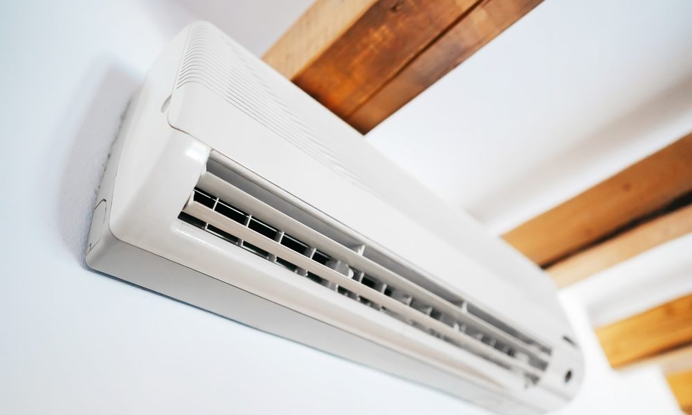 White air conditioning unit mounted onto a white wall